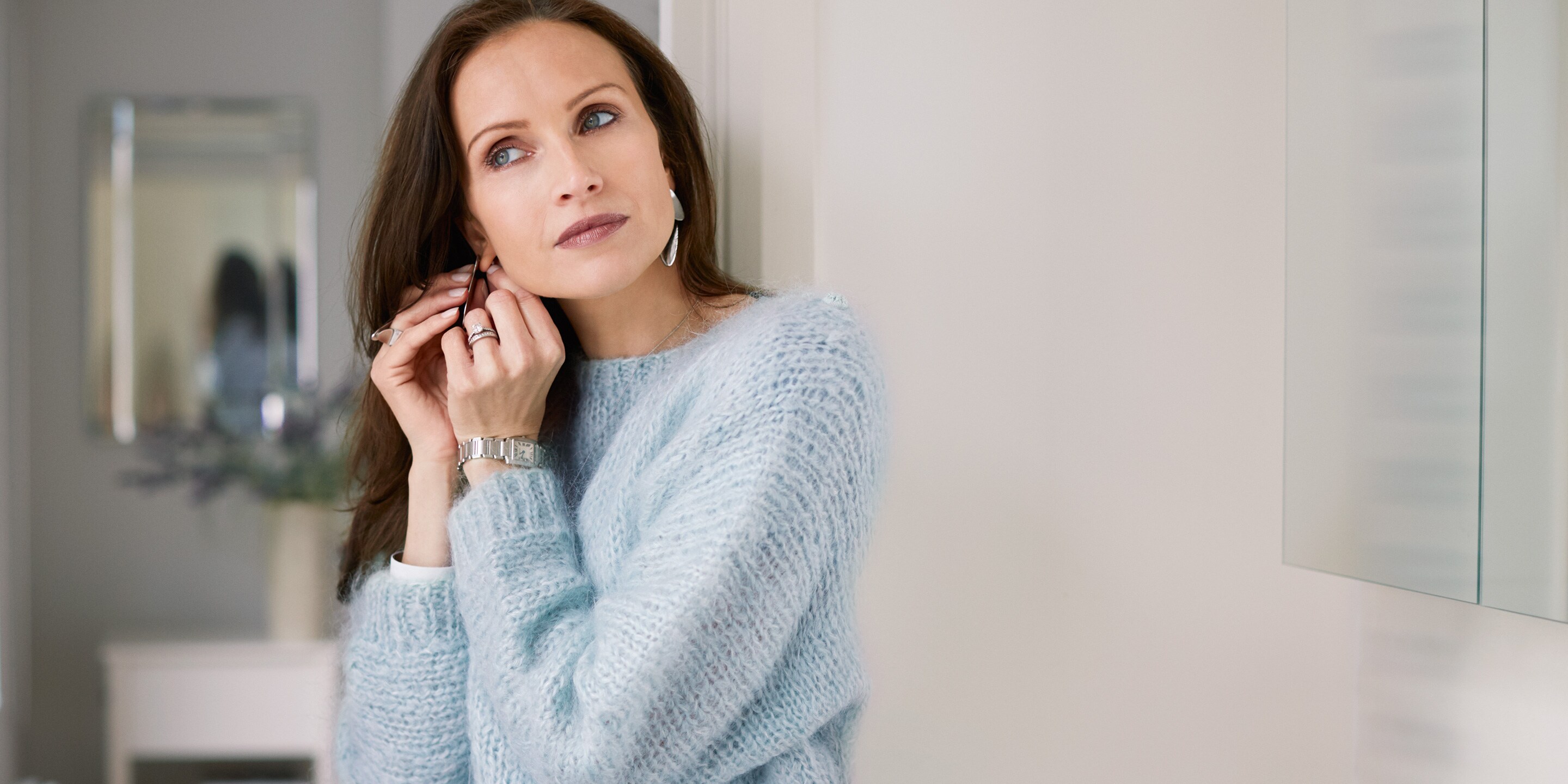 A women admiring her blue woollen jumper