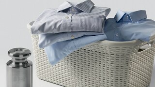A pile of shirts in a laundry basket